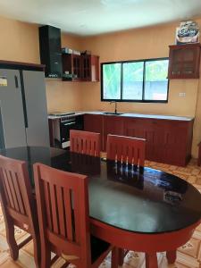 a kitchen with a dining room table and chairs at Dorz Inn in Basdiot