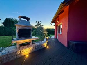 a brick oven on a deck next to a house at Dům Stašov in Stašov