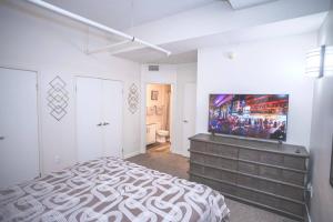 a bedroom with a bed and a flat screen tv at Urban Escape in Indianapolis +40 photos