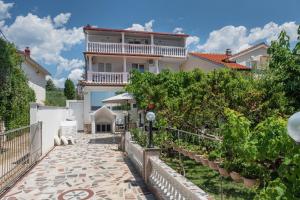 a large house with a walkway in front of it at K&D Home in Rab