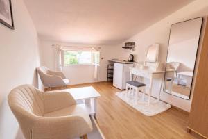 a living room with a table and chairs and a kitchen at K&D Home in Rab +10 photos