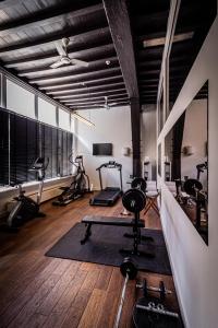 a gym with several exercise equipment in a room at Grand Hotel en Résidence De Draak in Bergen op Zoom