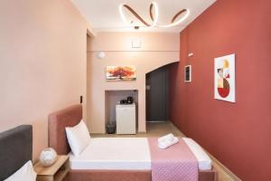 a room with a bed and a small refrigerator at Swan Paradise Tolo in Tolo