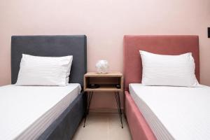 two beds sitting next to each other in a room at Swan Paradise Tolo in Tolo +129 photos