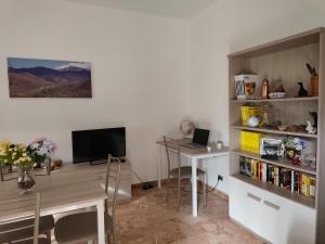 a room with a desk and a table with a laptop at Casa Roncopiano in Cabanne