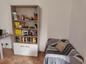 a living room with a couch and a book shelf at Casa Roncopiano in Cabanne +49 photos