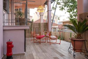 a patio with chairs and a table and a fire hydrant at Art and Light in Argostoli