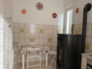 a kitchen with a table and a stove at Casa Roncopiano in Cabanne