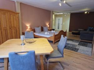 a living room with a dining table and a bed at Gästehaus La Puccia in Mittenwald +3 photos
