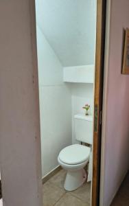 a bathroom with a white toilet in a room at Duplex EyC in Colón +11 photos