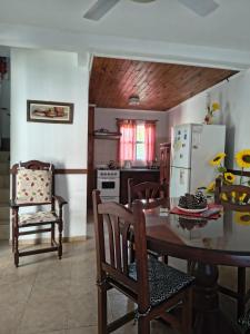 a kitchen with a table and chairs and a refrigerator at Duplex EyC in Colón