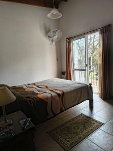 a bedroom with a bed and a large window at Duplex EyC in Colón