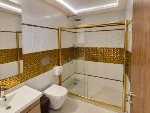 a bathroom with a shower and a toilet and a sink at ECRİN OTEL in Uzungöl +58 photos
