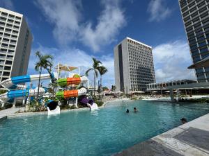 a pool with a water slide in a city at Salinas Beach Resort in Salinópolis