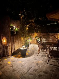 a patio with benches and a fountain at night at maderedocevida in Boaventura +122 photos