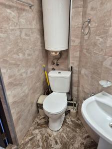 a small bathroom with a toilet and a sink at Къща за гости Баврия in Ravda +10 photos
