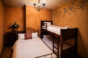 a bedroom with two bunk beds and a chandelier at Hotel Ines Maria in Cuenca