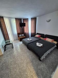a bedroom with a bed with two towels on it at Къща за гости Баврия in Ravda