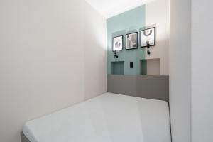 a white room with three pictures on the wall at Arthur's Home in Miskolc