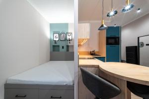 a kitchen with a counter and a blue refrigerator at Arthur's Home in Miskolc +6 photos