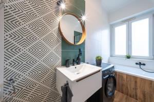 a bathroom with a sink and a mirror at Arthur's Home in Miskolc