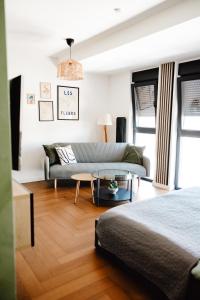 a living room with two beds and a couch at Zs Apartment in Tuzla