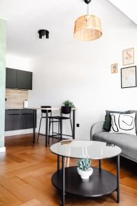 a living room with a couch and a table at Zs Apartment in Tuzla
