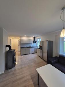 a living room with a couch and a stove at Boose Apart in Kobela