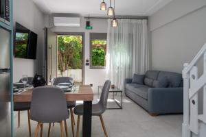 a living room with a table and a blue couch at Blue Horizon luxury residence in Kanali