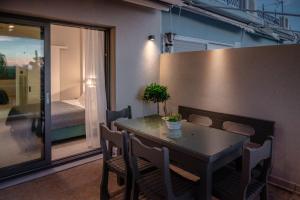 a dining room with a table and chairs and a bedroom at Blue Horizon luxury residence in Kanali