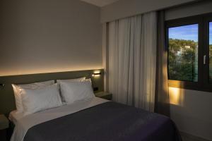 a bedroom with a large bed and a window at Blue Horizon luxury residence in Kanali