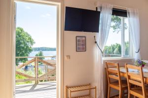 a door leading to a balcony with a view of the water at Visitor Stugby in Håverud