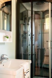 a bathroom with a shower and a white sink at Visitor Stugby in Håverud