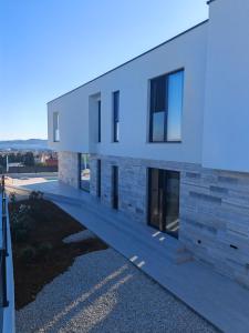 a large white building with windows on the side at White Hills Villa in Zadar
