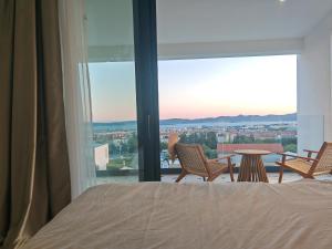 a bedroom with a bed and a view of the city at White Hills Villa in Zadar