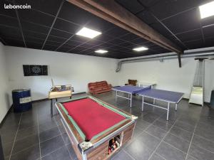 a room with two ping pong tables in it at Gîte Le petit Fresnay in Le Bourgneuf-la-Forêt