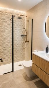 a bathroom with a shower and a toilet and a sink at Aurah Home in Tudela +12 photos