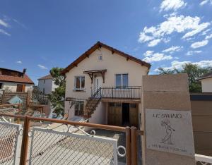 a house with a sign in front of it at Meublé de Tourisme Le Swing in Marsannay-la-Côte