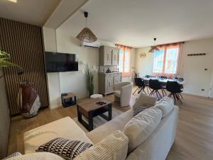 a living room with a couch and a table at Meublé de Tourisme Le Swing in Marsannay-la-Côte