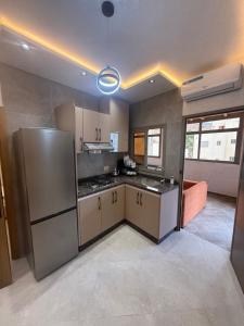 a kitchen with a stainless steel refrigerator in a room at اقامة هبة 6 in Yebha