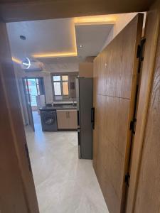a kitchen with a refrigerator and a stove at اقامة هبة 6 in Yebha +7 photos