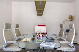 a glass table with chairs around it in a room at Luxury Panoramic Loft with heated saltwater pool and parking near Taormina, Catania, the Sea and Mount Etna by SicilianRelaxingHomes in Giarre +181 photos