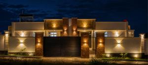 a building with lights on the side of it at night at ExtraMile Apartments - 2BR-R in Dodoma