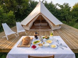 a table with food in front of a tent at Langeland Camping in Rudkøbing