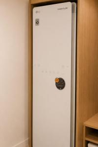 a refrigerator with a sticker on the side of a wall at 윤스테이 행궁 호텔-Yoonstay Haenggung in Suwon