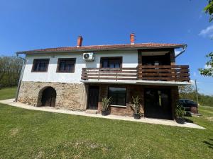 a large stone house with a yard at Imanje Kovačević in Gornji Milanovac