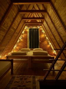 a room with a bed with lights on it at STANET Forest Houses in Novoberdo