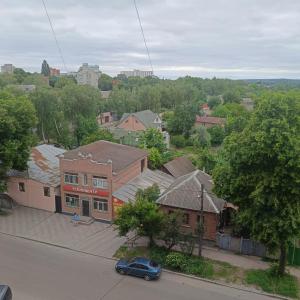 an aerial view of a town with houses and a car at Квартира in Sumy
