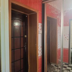 an open door in a room with red walls at Квартира in Sumy