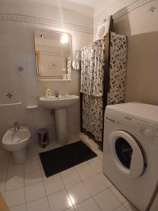 a bathroom with a washing machine and a sink at Casa Campani in Monclassico
